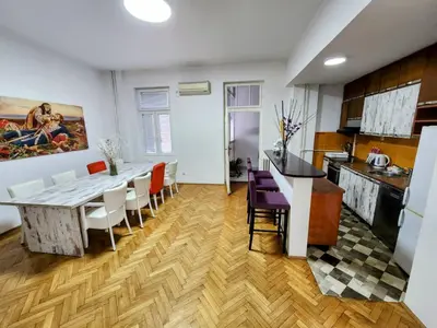 a kitchen and dining room with a table and chairs at BUDGET - Authentic Belgrade Centre Apartment #4, 3 Bedrooms, 1 full Bathroom, 1 Toilet in Belgrade