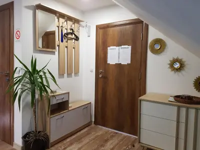 a hallway with a closet and a wooden door at Ćukovac studios in Belgrade