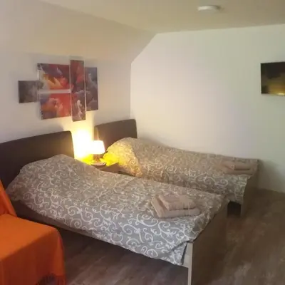 a small room with two beds and a lamp at Ćukovac studios in Belgrade