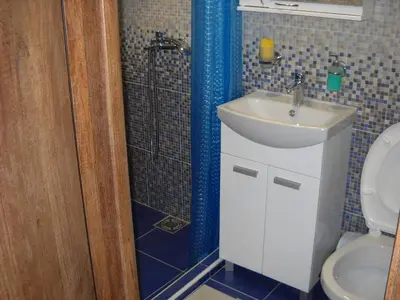 a bathroom with a shower and a sink and a toilet at Ćukovac studios in Belgrade