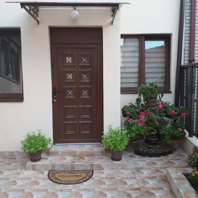a front door of a house with potted plants at Ćukovac studios in Belgrade