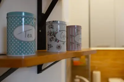 three tin cans sitting on a wooden shelf at Your ONE and ONLY in Belgrade