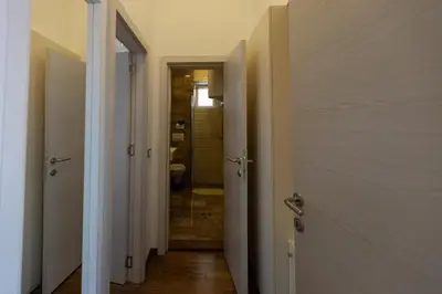 a hallway with a bathroom with a shower and a toilet at Your ONE and ONLY in Belgrade