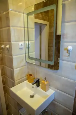 a bathroom with a sink and a mirror at Your ONE and ONLY in Belgrade