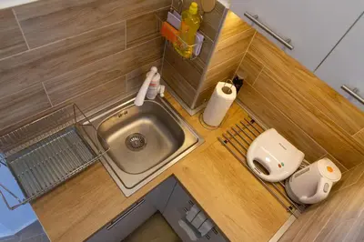 a small kitchen with a sink and a toilet at Your ONE and ONLY in Belgrade