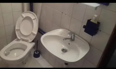a white bathroom with a toilet and a sink at Juliana in Belgrade