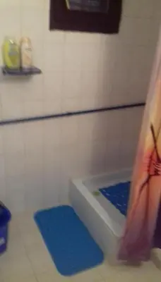 a bathroom with a bath tub with a blue mat at Juliana in Belgrade