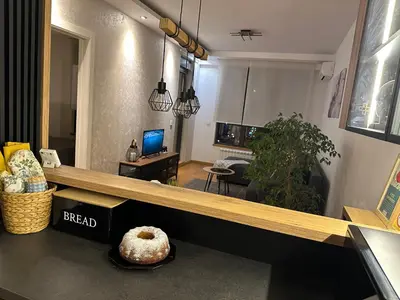 a living room with a table with a doughnut on it at Apartment Unamare in Belgrade
