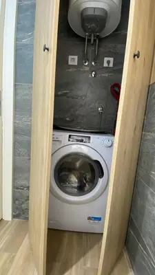 a washer and dryer in a small room at Apartment Unamare in Belgrade
