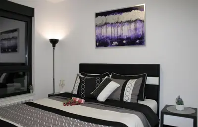 a bedroom with a bed with black and white pillows at Spa Panorama in Belgrade