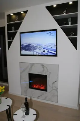 a living room with a fireplace and a flat screen tv at Spa Panorama in Belgrade
