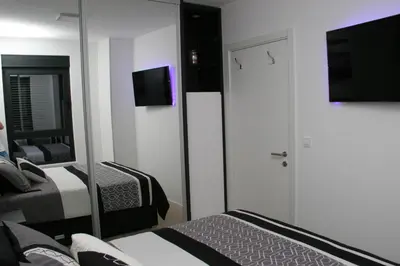 a hotel room with two beds and a mirror at Spa Panorama in Belgrade