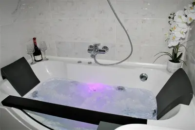 a bath tub filled with water in a bathroom at Spa Panorama in Belgrade
