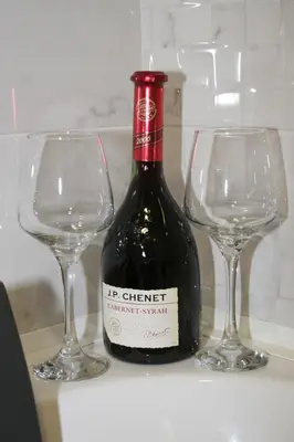 a bottle of wine next to two wine glasses at Spa Panorama in Belgrade