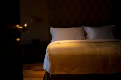 a bedroom with a bed with white sheets and pillows at FLOW in Belgrade