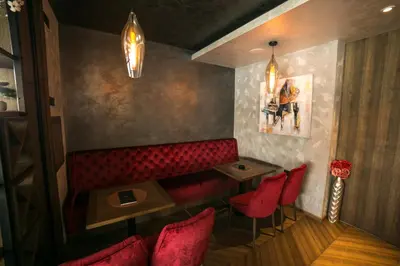 a restaurant with a red booth and red chairs at FLOW in Belgrade