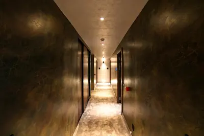 a hallway with metal walls and a long corridor at FLOW in Belgrade