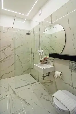 a bathroom with a toilet and a sink and a mirror at Momo 123 Apartments in Belgrade