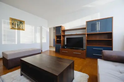 a living room with a couch and a flat screen tv at BB´s Apartment&Unterkunft in Belgrade