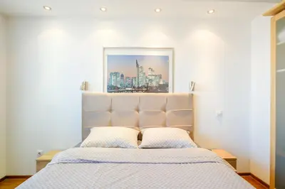 a bedroom with a bed with a picture above it at BB´s Apartment&Unterkunft in Belgrade