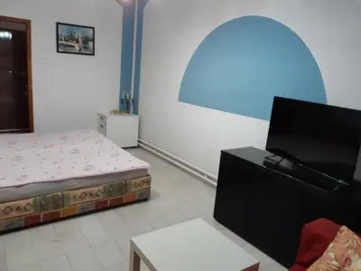 a bedroom with a bed and a flat screen tv at Prenociste Pecinci in Pećinci