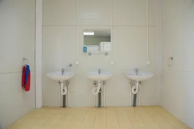 a bathroom with two sinks and a mirror at Prenociste Pecinci in Pećinci