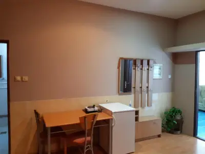 a kitchen with a wooden table and a table and chairs at Prenociste Pecinci in Pećinci