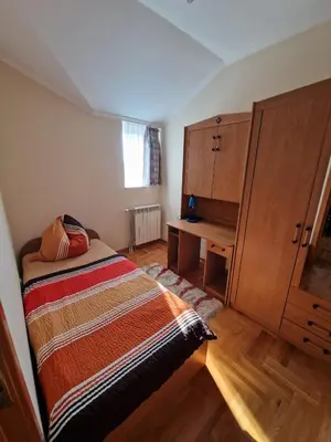 a small bedroom with a bed and a desk at Danube duplex apartment in Smederevo
