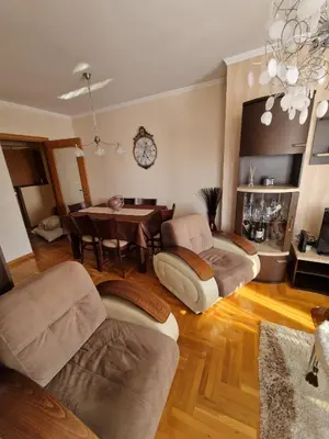 a living room with a table and a dining room at Danube duplex apartment in Smederevo