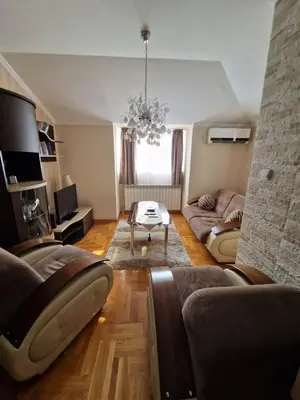 a living room with a couch and a table at Danube duplex apartment in Smederevo