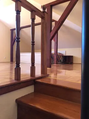 a wooden staircase with wooden floors and wooden beams at Danube duplex apartment in Smederevo