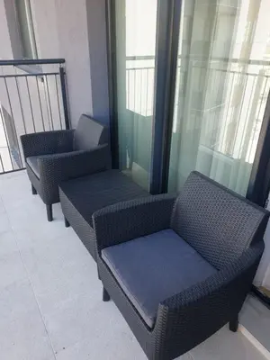 a row of chairs in a room with windows at Belgrade Waterfront-Delux apartman Beograd na vodi in Belgrade