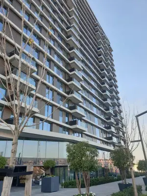 a large apartment building with balconies and trees at Belgrade Waterfront-Delux apartman Beograd na vodi in Belgrade
