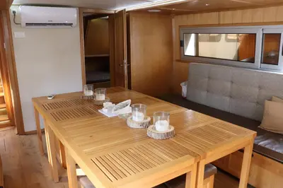 a wooden table with glasses on it in a room at Free Room Boat Apartment in Belgrade