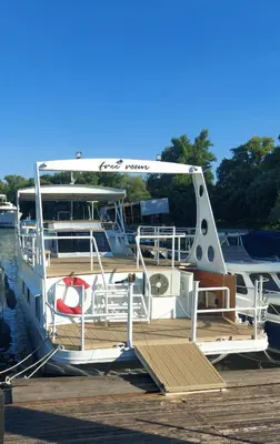a boat is docked at a dock at Free Room Boat Apartment in Belgrade