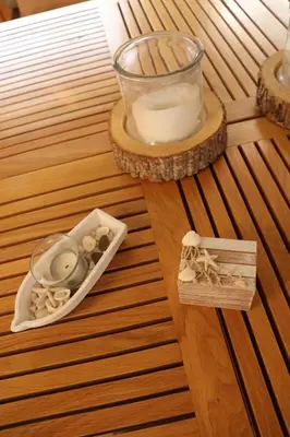 aambooamboo table with a candle and a bowl of shells at Free Room Boat Apartment in Belgrade
