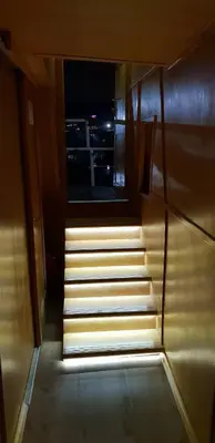 a stairway with a view of a city at night at Free Room Boat Apartment in Belgrade