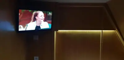 a television on a door with a woman on it at Free Room Boat Apartment in Belgrade