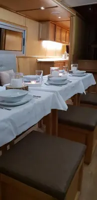 a table with white plates and dishes on it at Free Room Boat Apartment in Belgrade