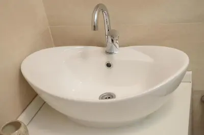a white sink with a faucet in a bathroom at Stella Apartments in Belgrade