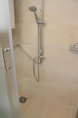 a shower with a shower head in a bathroom at Stella Apartments in Belgrade