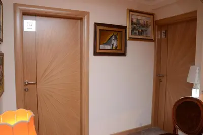 a hallway with a door and a picture of a horse at Stella Apartments in Belgrade