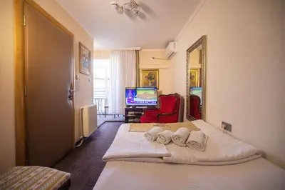 a hotel room with a bed and a television at Stella Apartments in Belgrade