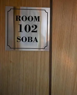a sign on a door that reads room soba at Stella Apartments in Belgrade