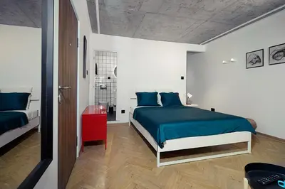 a bedroom with a bed with blue pillows at Tulum Apart Belgrade in Belgrade