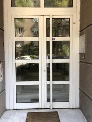 a door with three glass windows on a building at Tulum Apart Belgrade in Belgrade