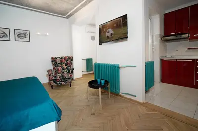 a room with a bed and a table and a chair at Tulum Apart Belgrade in Belgrade