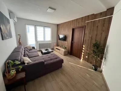 a living room with a couch and a television at Panorama View Belgrade in Belgrade
