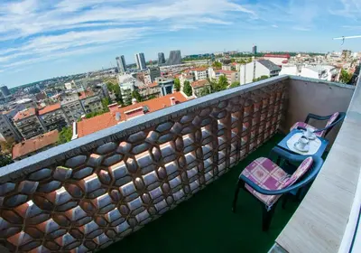 two chairs on a balcony with a view of a city at Panorama View Belgrade in Belgrade