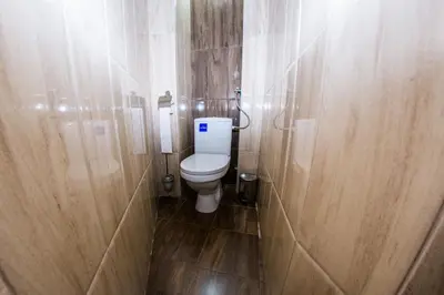 a small bathroom with a toilet and wooden walls at Panorama View Belgrade in Belgrade